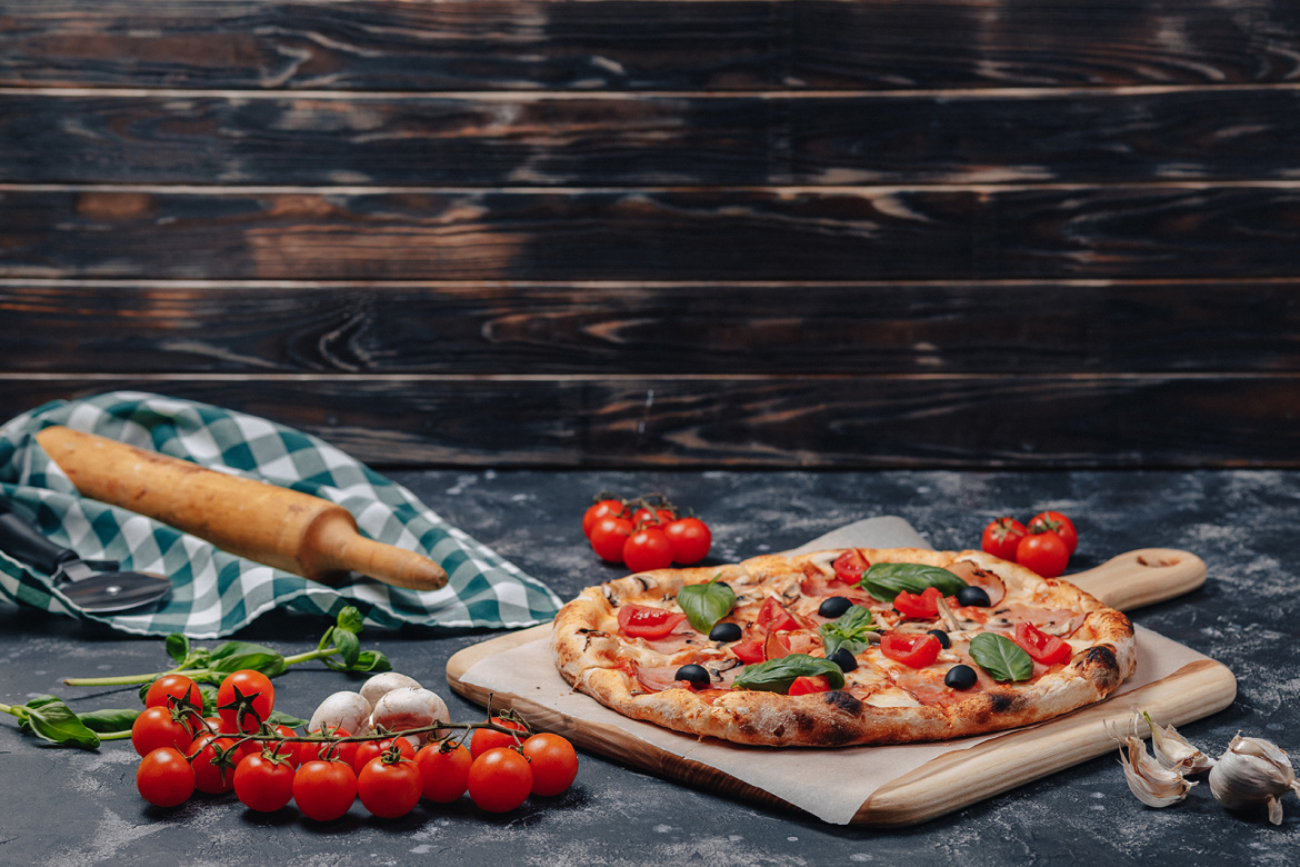 delicious-neapolitan-pizza-on-board-with-cherry-tomatoes-free-space-for-text.jpg